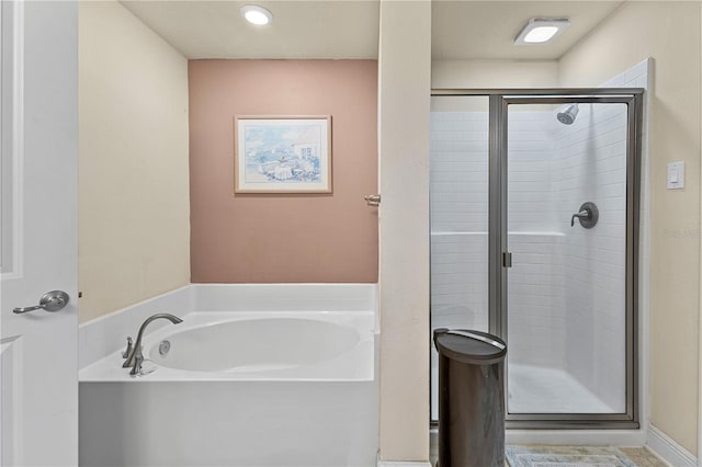 full bath with a bath and a shower stall