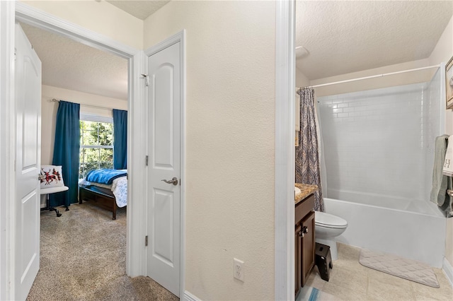 full bathroom with a textured ceiling, a textured wall, and vanity