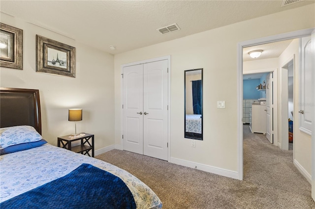 carpeted bedroom featuring baseboards, a textured ceiling, visible vents, and a closet