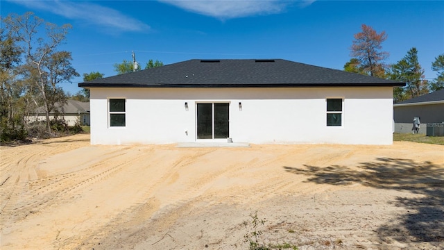 16407 SW 21st Terrace Rd, Ocala, FL 34473 - rear view of house featuring a shingled roof, cooling unit, and stucco siding