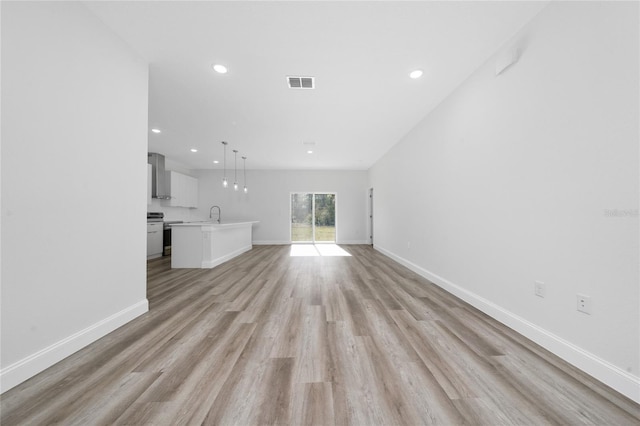 16407 SW 21st Terrace Rd, Ocala, FL 34473 - unfurnished living room with light wood finished floors, baseboards, visible vents, and recessed lighting