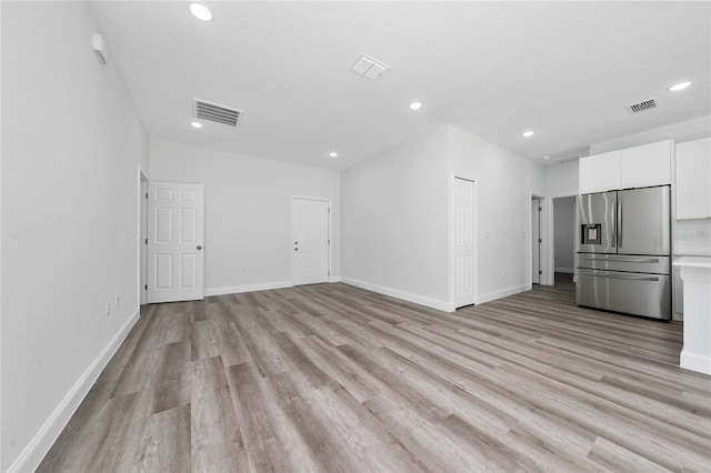 16407 SW 21st Terrace Rd, Ocala, FL 34473 - unfurnished living room featuring light wood-type flooring, recessed lighting, and visible vents