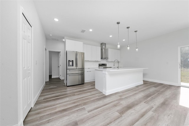 16407 SW 21st Terrace Rd, Ocala, FL 34473 - kitchen with light countertops, white cabinetry, stainless steel appliances, wall chimney range hood, and visible vents