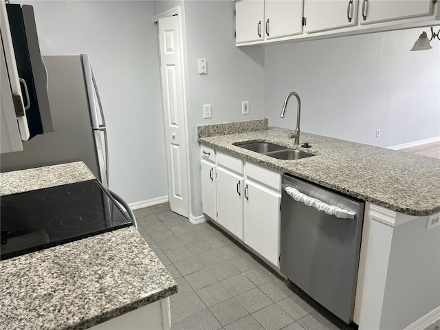 2020 Royal Bay Blvd Unit 92, Kissimmee, FL 34746 - kitchen featuring stainless steel dishwasher, a sink, black range with electric stovetop, white cabinetry, and baseboards