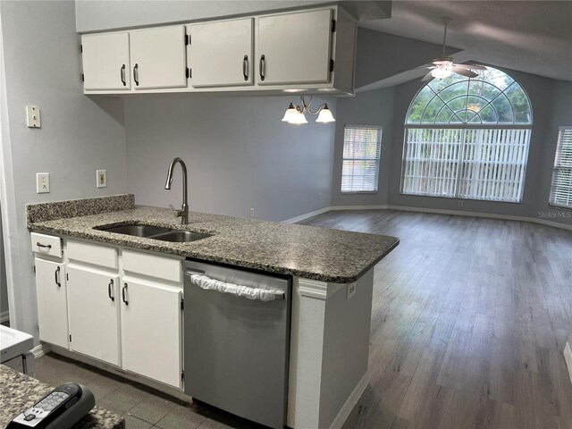 2020 Royal Bay Blvd Unit 92, Kissimmee, FL 34746 - kitchen featuring dishwasher, a sink, ceiling fan, white cabinetry, and lofted ceiling