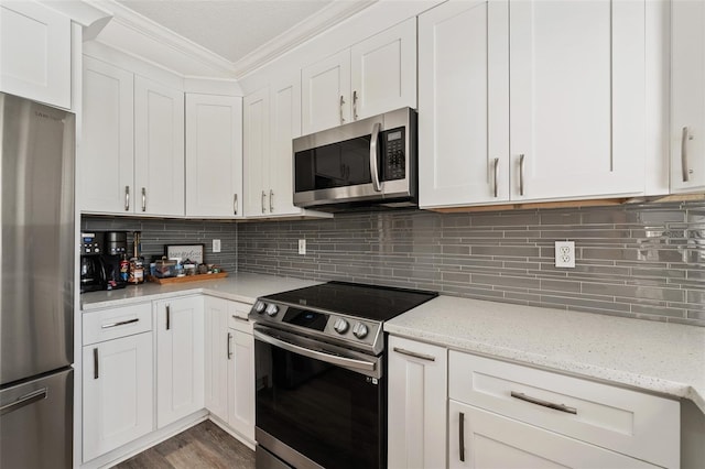 kitchen with light stone counters, crown molding, white cabinets, decorative backsplash, and appliances with stainless steel finishes