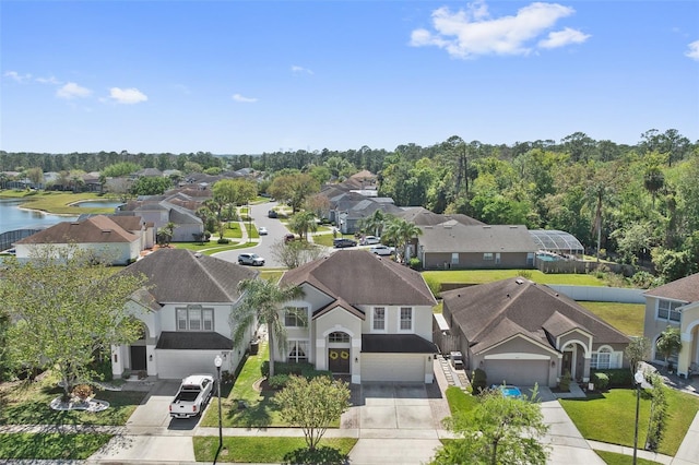 drone / aerial view featuring a water view and a residential view