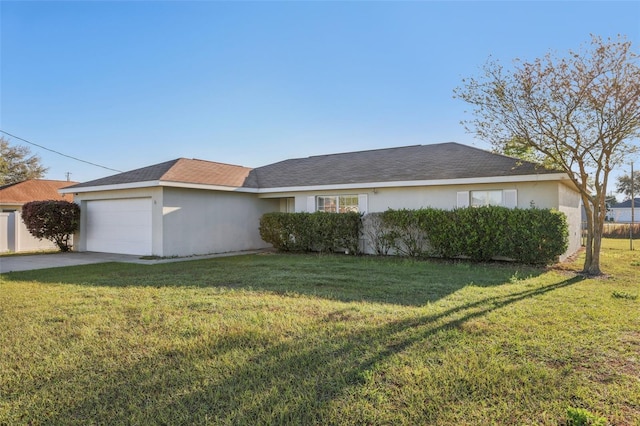 view of side of property with concrete driveway, stucco siding, a garage, and a yard
