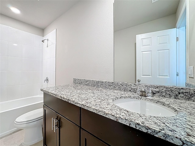 bathroom featuring tile patterned flooring, toilet, vanity, and washtub / shower combination