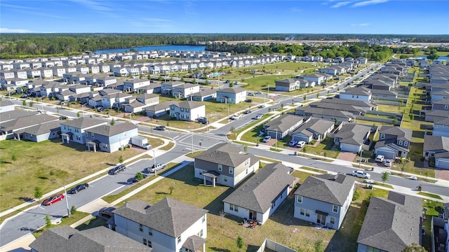drone / aerial view with a residential view and a water view