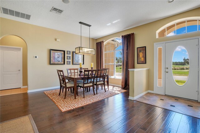 entrance foyer featuring wood finished floors, visible vents, and a textured ceiling