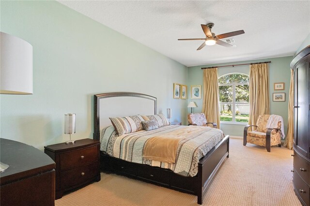 bedroom with a ceiling fan, light colored carpet, and visible vents