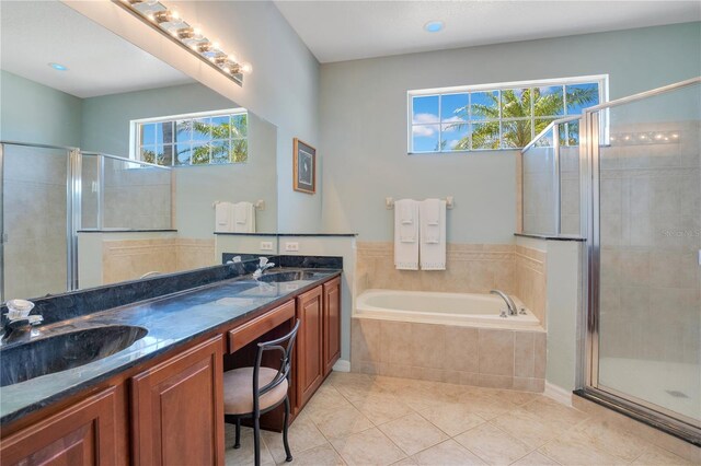 full bath with a sink, plenty of natural light, a bath, and a shower stall
