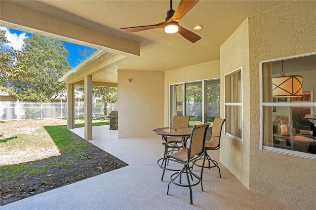 view of patio / terrace with grilling area, ceiling fan, and fence
