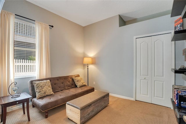 living room with baseboards and light colored carpet