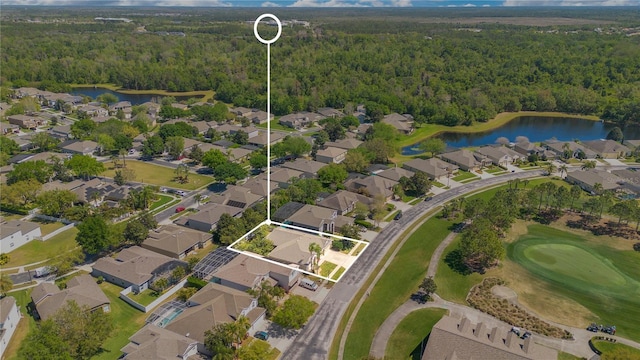 birds eye view of property featuring a residential view, a water view, view of golf course, and a wooded view