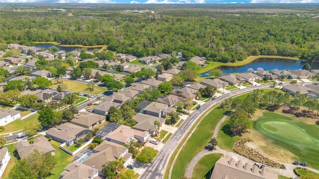 birds eye view of property featuring a residential view, a view of trees, and a water view