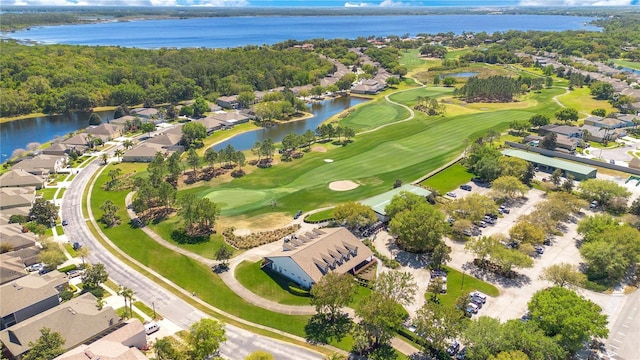 drone / aerial view featuring a residential view, a water view, and view of golf course
