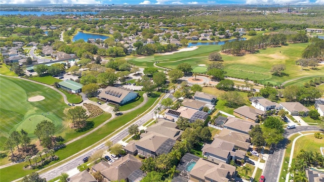 aerial view with a residential view, a water view, and view of golf course
