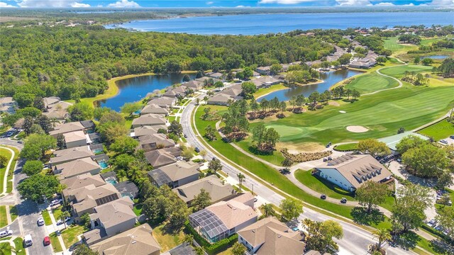 bird's eye view featuring a residential view, a water view, a wooded view, and golf course view