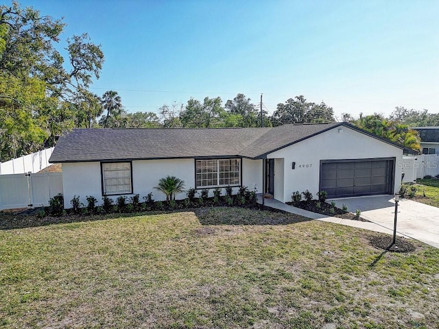 4907 21st Ave W, Bradenton, FL 34209 - single story home with a front yard, fence, driveway, stucco siding, and a garage