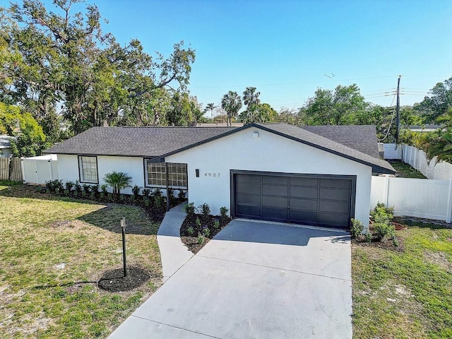 4907 21st Ave W, Bradenton, FL 34209 - ranch-style home featuring stucco siding, fence, concrete driveway, a front yard, and a garage