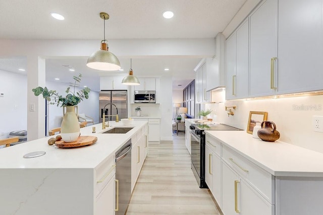 4907 21st Ave W, Bradenton, FL 34209 - kitchen with light countertops, recessed lighting, appliances with stainless steel finishes, white cabinets, and a sink