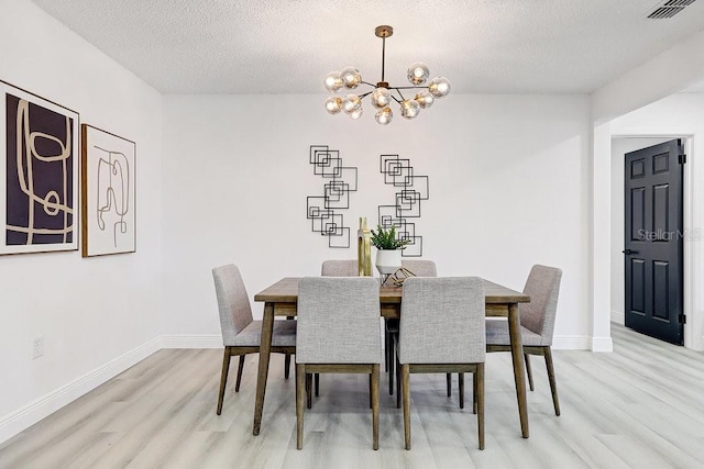 4907 21st Ave W, Bradenton, FL 34209 - dining room featuring a notable chandelier, light wood-style floors, visible vents, and baseboards