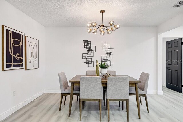 4907 21st Ave W, Bradenton, FL 34209 - dining room with visible vents, light wood-style flooring, baseboards, and an inviting chandelier