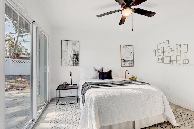 4907 21st Ave W, Bradenton, FL 34209 - bedroom with access to outside, multiple windows, a ceiling fan, and baseboards