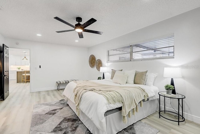 4907 21st Ave W, Bradenton, FL 34209 - bedroom with light wood-style flooring, baseboards, and a textured ceiling
