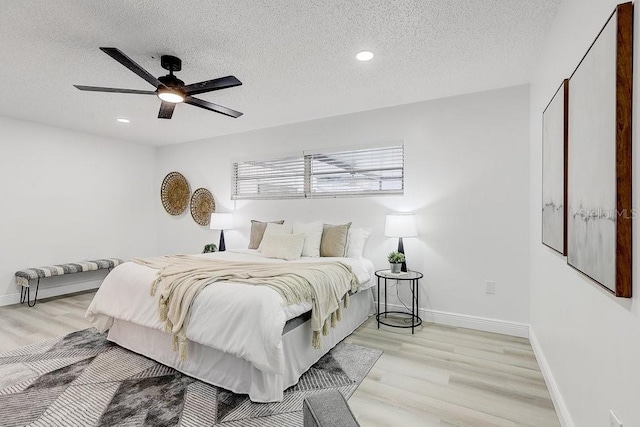 4907 21st Ave W, Bradenton, FL 34209 - bedroom featuring baseboards, a textured ceiling, and light wood-style flooring