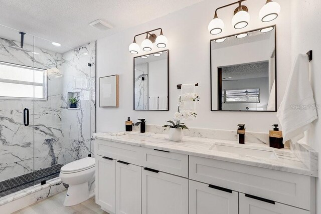 4907 21st Ave W, Bradenton, FL 34209 - bathroom with a sink, a marble finish shower, toilet, and a textured ceiling