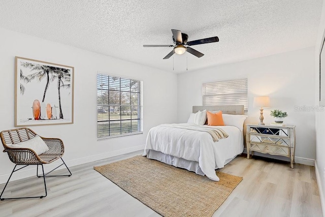 4907 21st Ave W, Bradenton, FL 34209 - bedroom with light wood-type flooring, baseboards, and a textured ceiling