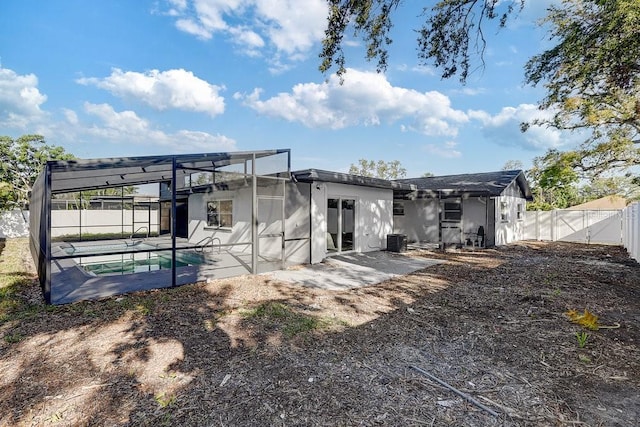 4907 21st Ave W, Bradenton, FL 34209 - back of house with glass enclosure, a patio, a gate, central AC unit, and a fenced backyard