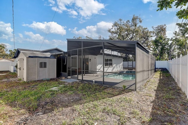 4907 21st Ave W, Bradenton, FL 34209 - back of property with a storage unit, a patio, a fenced backyard, an outdoor structure, and a fenced in pool