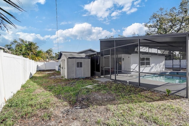 4907 21st Ave W, Bradenton, FL 34209 - exterior space featuring a fenced in pool, glass enclosure, a fenced backyard, an outdoor structure, and a storage unit