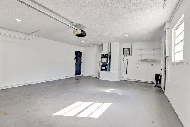 4907 21st Ave W, Bradenton, FL 34209 - garage featuring concrete block wall and a garage door opener