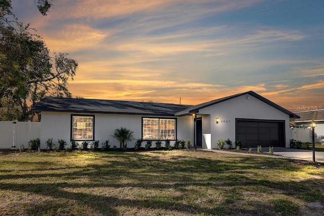 4907 21st Ave W, Bradenton, FL 34209 - view of front of house with a garage, stucco siding, driveway, and fence