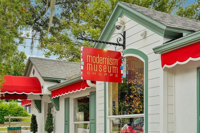 exterior details with gutters and a shingled roof