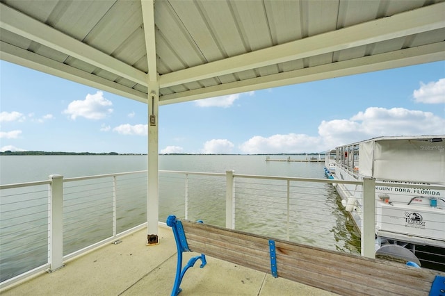 view of dock featuring a water view and a balcony