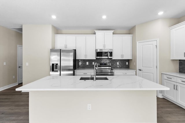 1973 E Celina St, Inverness, FL 34453 - kitchen with stainless steel appliances, a sink, an island with sink, tasteful backsplash, and white cabinetry