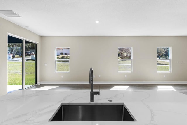 1973 E Celina St, Inverness, FL 34453 - kitchen with a sink, light stone countertops, open floor plan, and recessed lighting