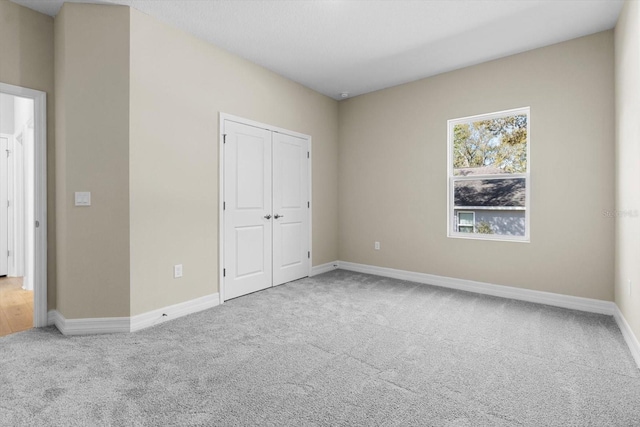 1973 E Celina St, Inverness, FL 34453 - unfurnished bedroom featuring carpet flooring, baseboards, and a closet