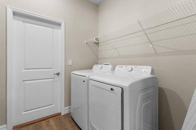 1973 E Celina St, Inverness, FL 34453 - washroom with washing machine and dryer, dark wood-style floors, and baseboards