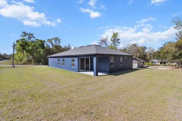 1973 E Celina St, Inverness, FL 34453 - rear view of house with a yard, stucco siding, and a patio area