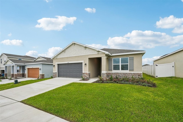 view of front of house with stone siding, fence, concrete driveway, a front yard, and a garage
