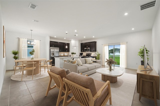 living room featuring light tile patterned floors, recessed lighting, and visible vents