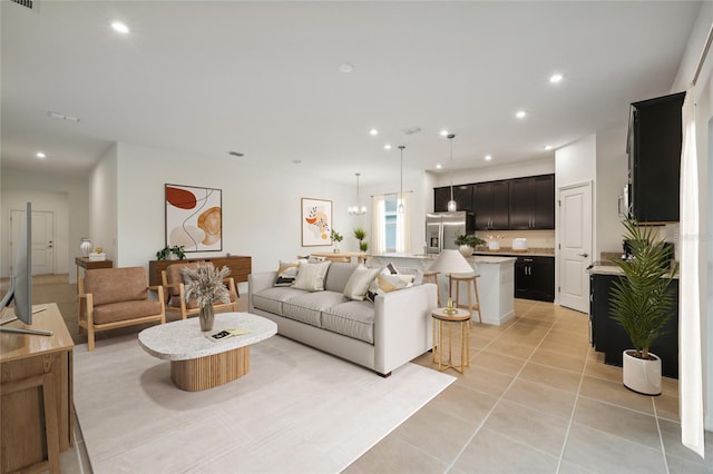 living room with light tile patterned flooring, visible vents, and recessed lighting