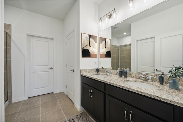 full bathroom featuring tile patterned floors, a stall shower, and a sink